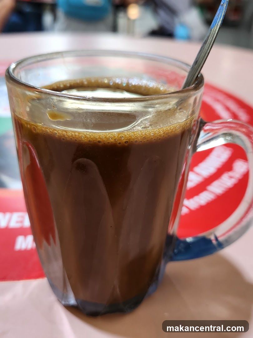 Coffee in glass mug with spoon