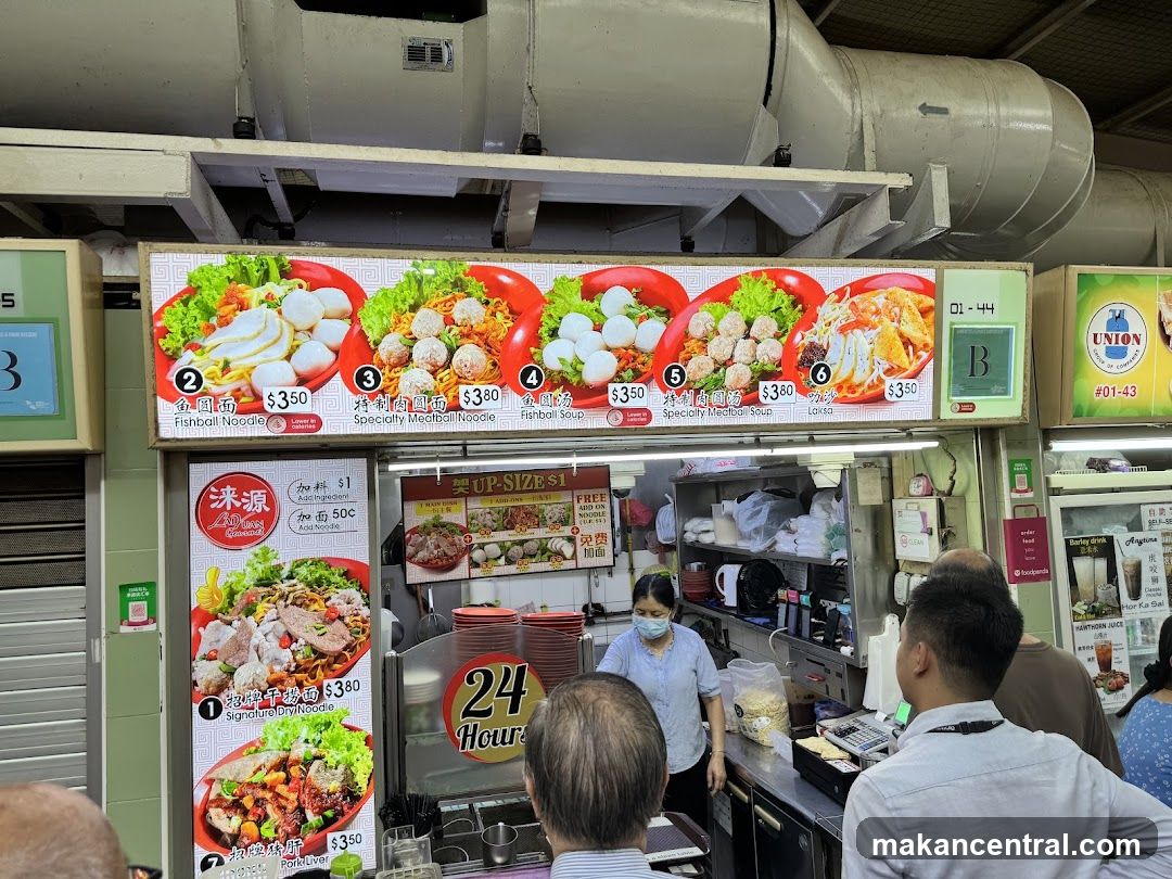 Food stall interior with customers and staff