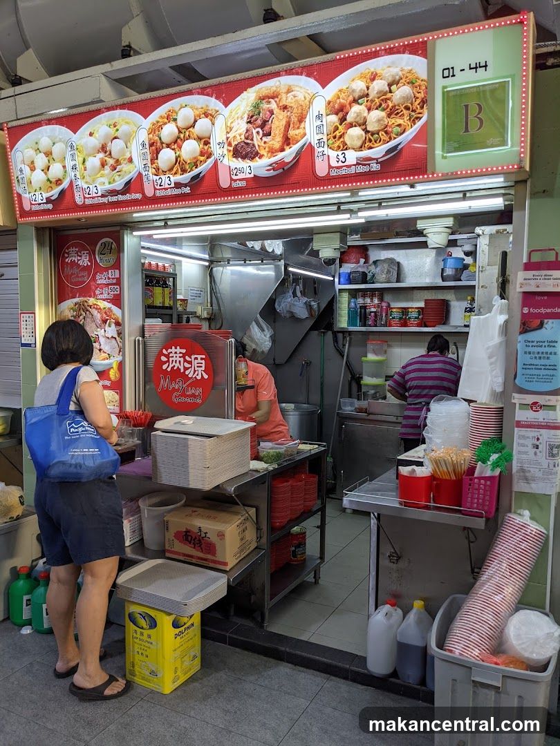 Food stall interior with customers and staff