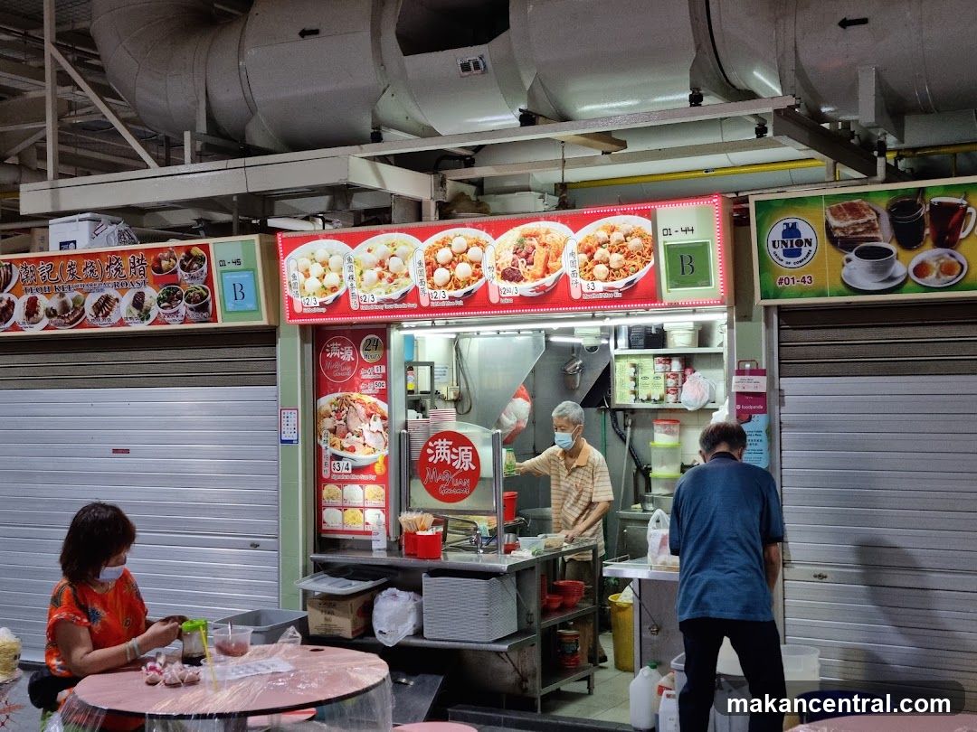 Food stall interior with customers and staff