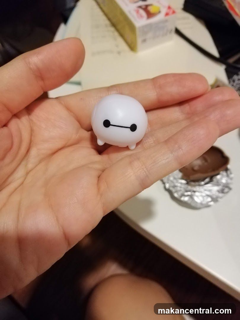 Hand holding small figurine