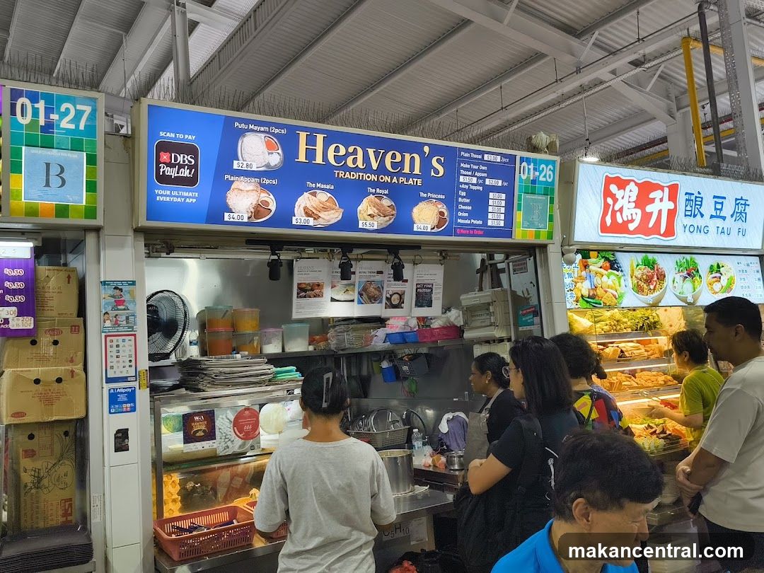 Food stall interior with customers and adjacent vendor
