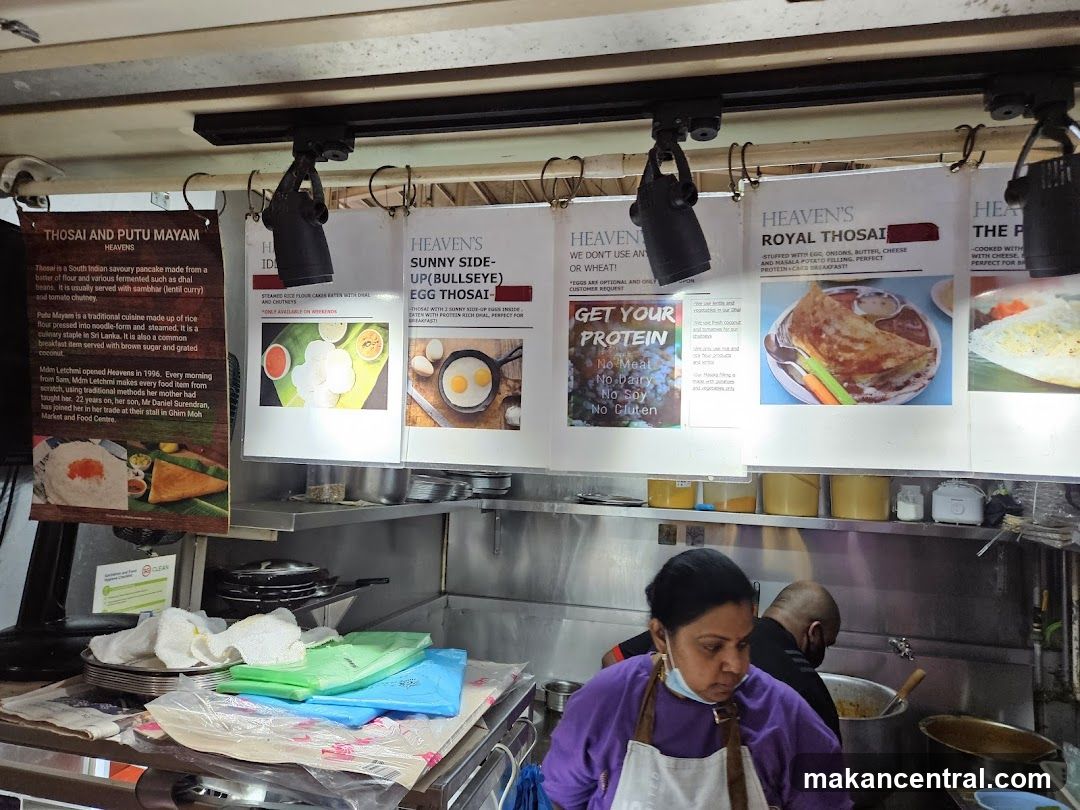 Food stall interior with staff and promotional posters