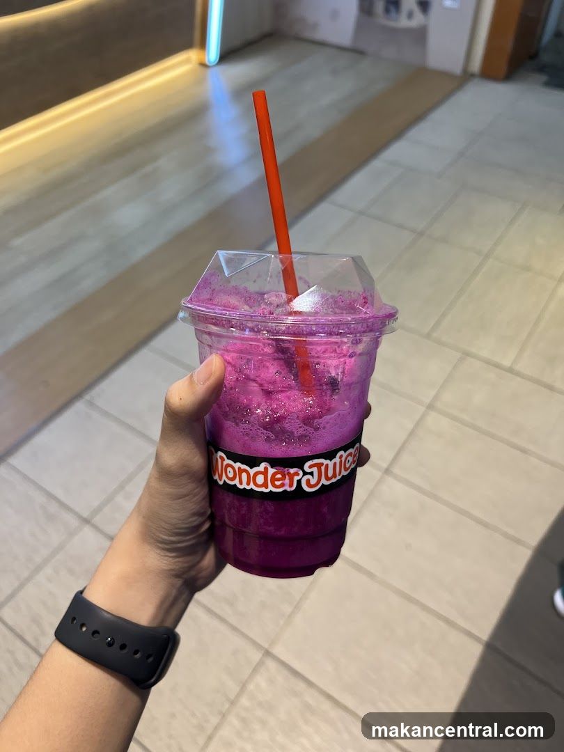 Hand holding a Wonder Juice drink