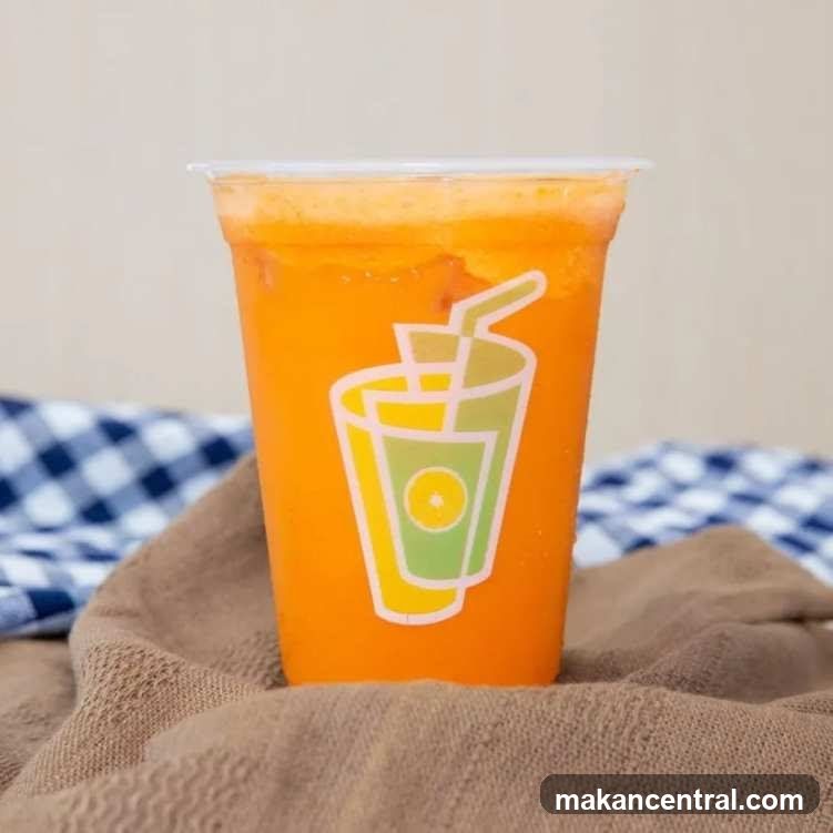Orange beverage in plastic cup