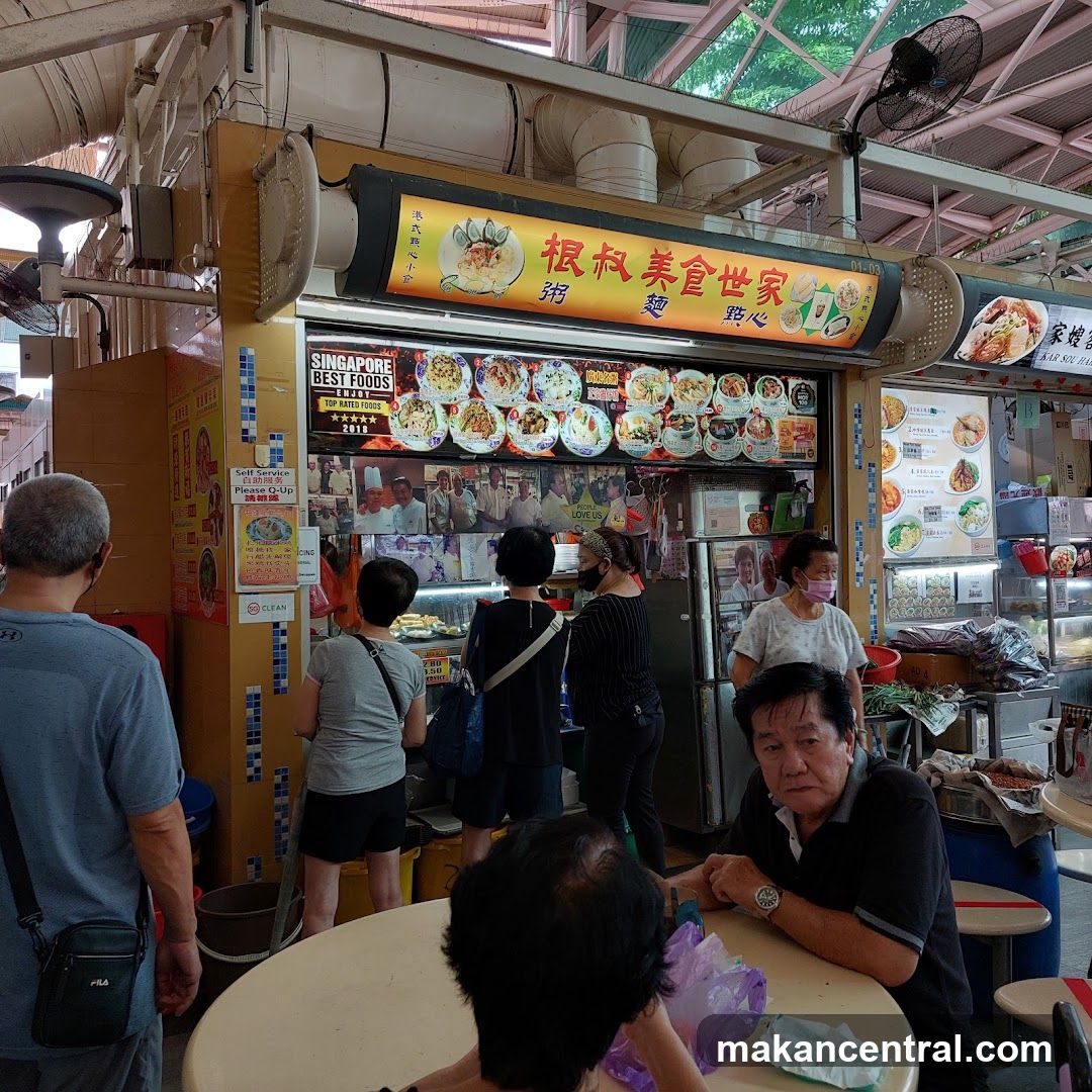 Food stall interior with customers and signage