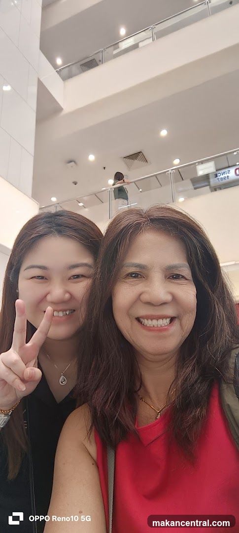 Two women taking selfie in a shopping mall interior