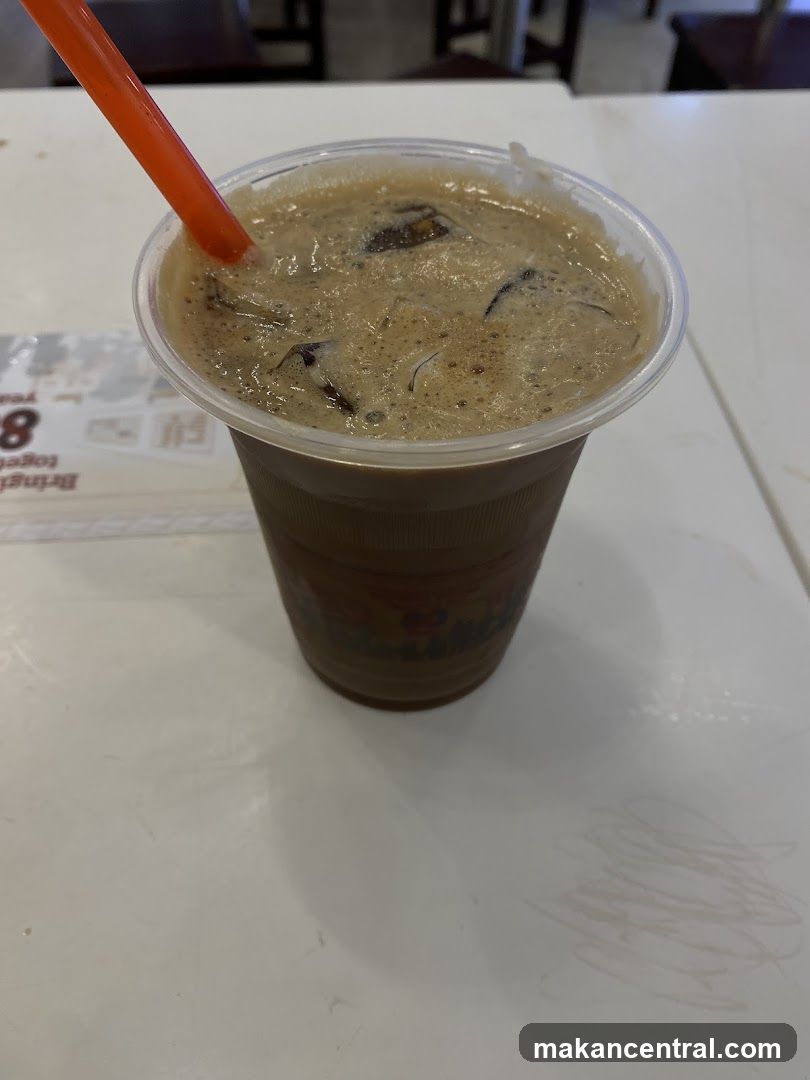 Iced beverage with straw on table