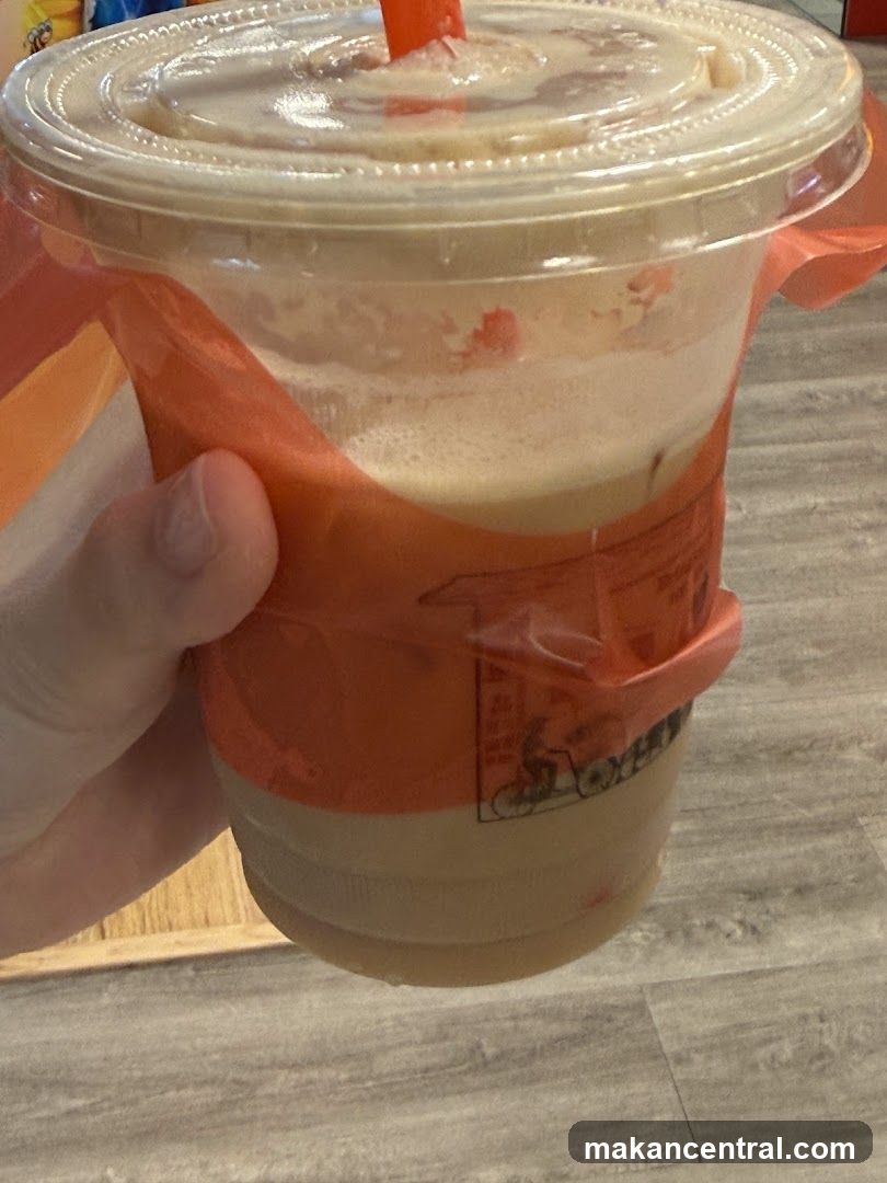 Hand holding iced beverage