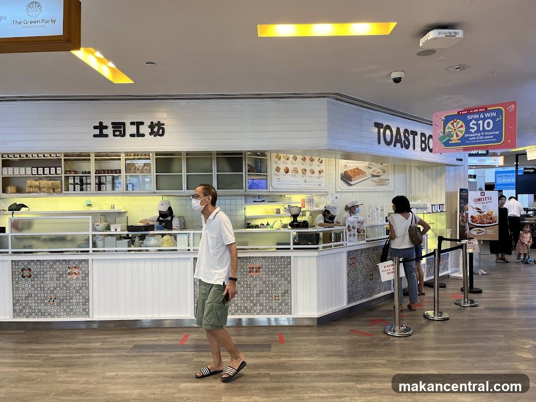 Inside a food court with Toast Box storefront