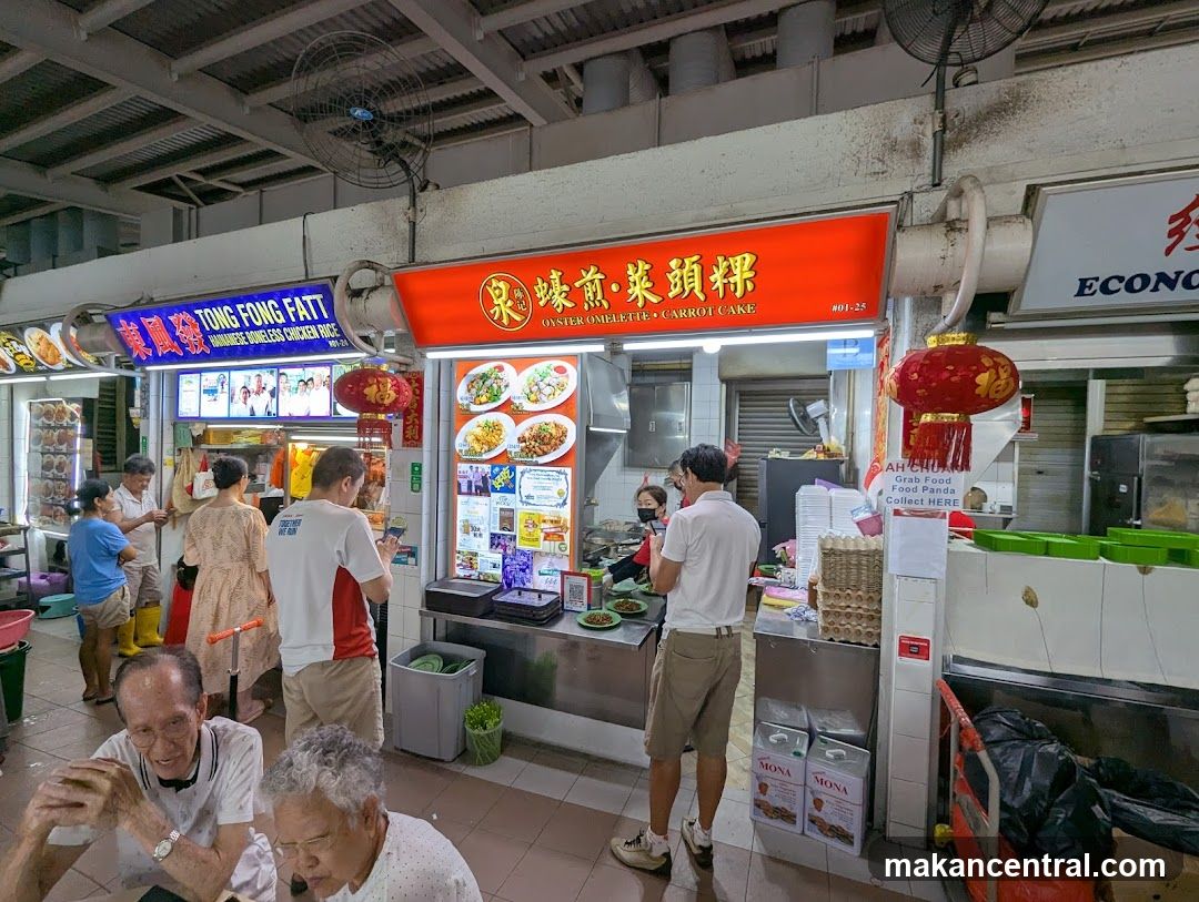 Food stall interior with customers and signage