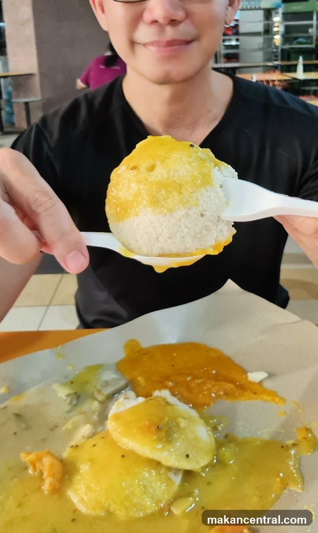 Person holding food with spoon