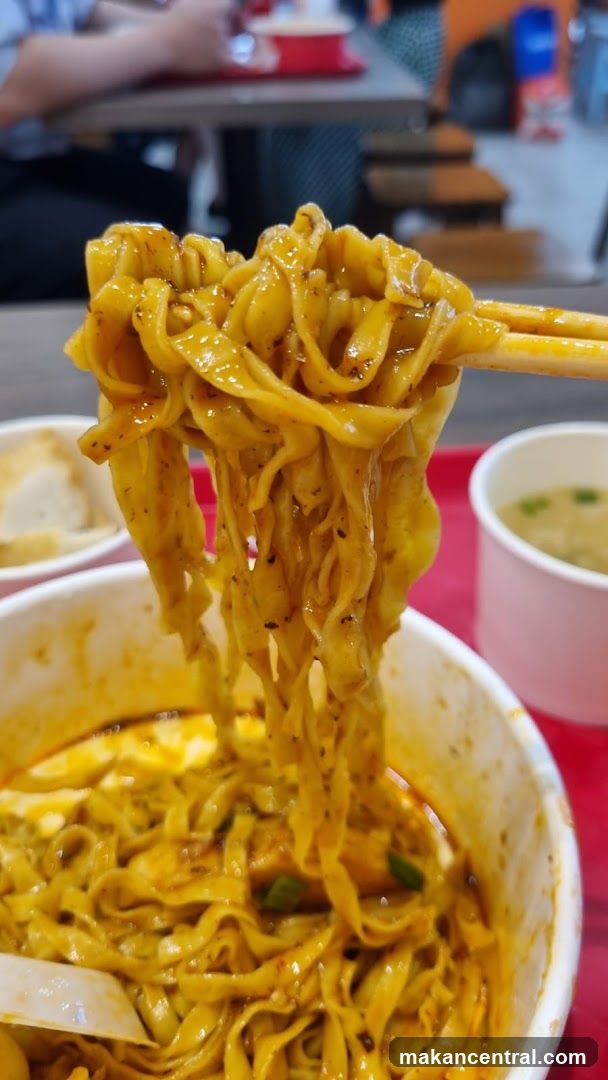 Noodles being lifted with chopsticks