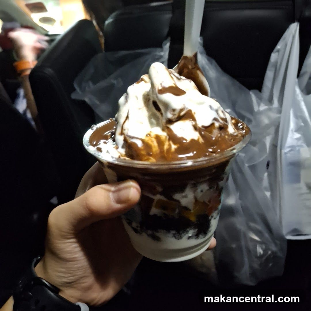 Hand holding dessert in car interior