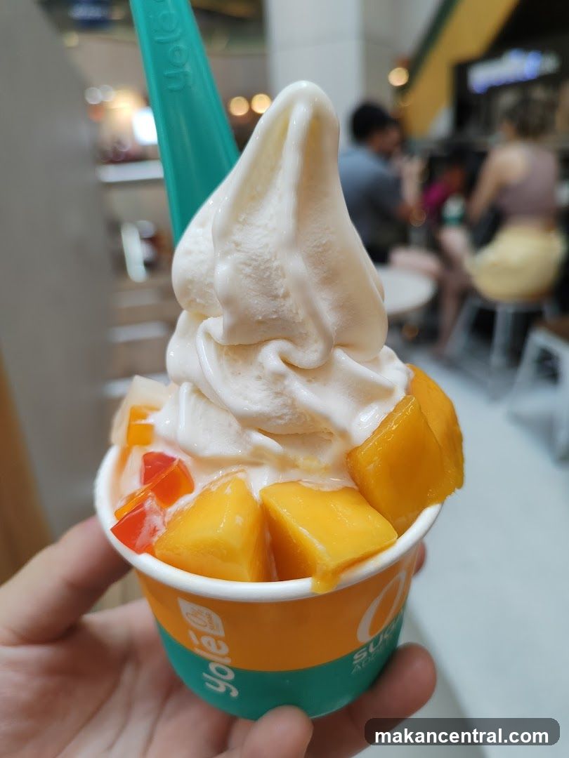 Soft serve dessert with mango and fruit pieces