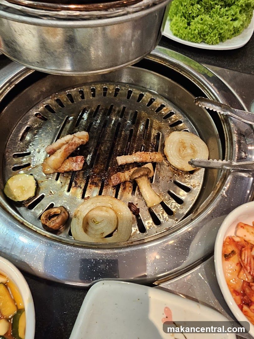 Grilled meat and vegetables on a Korean BBQ grill