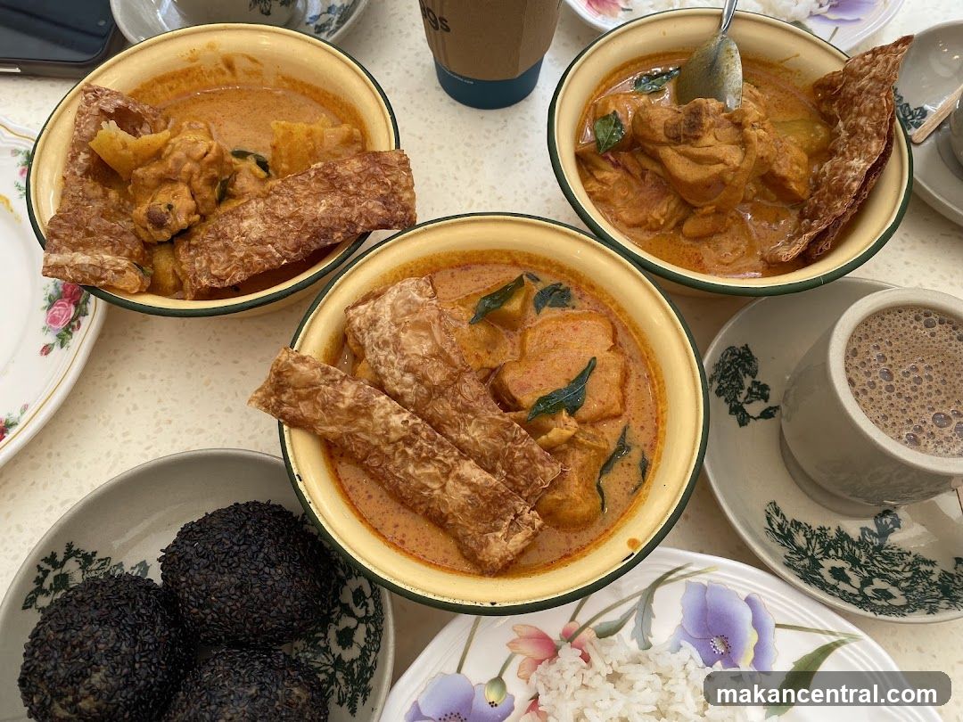 Table with curry dishes and beverages