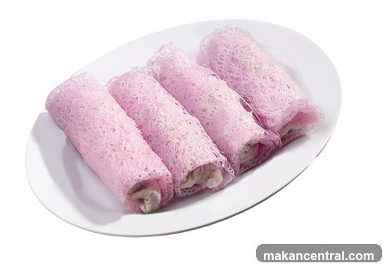 Pink rolled dessert on white plate