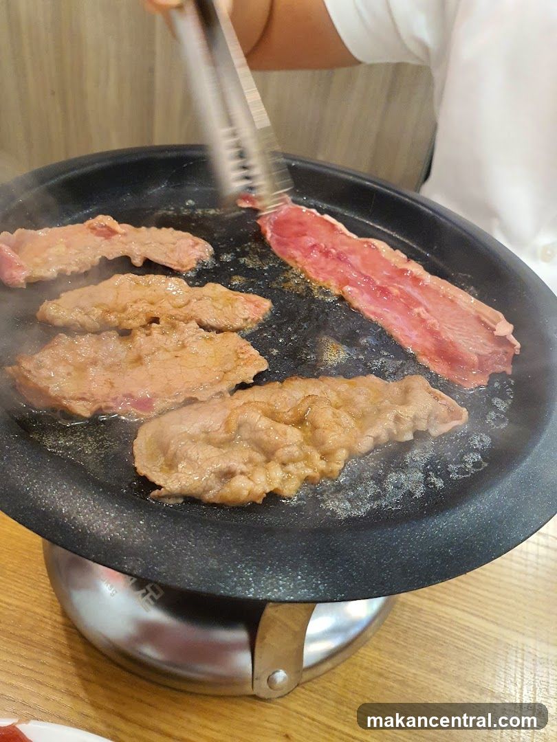 Grilled meat being cooked on a hot plate