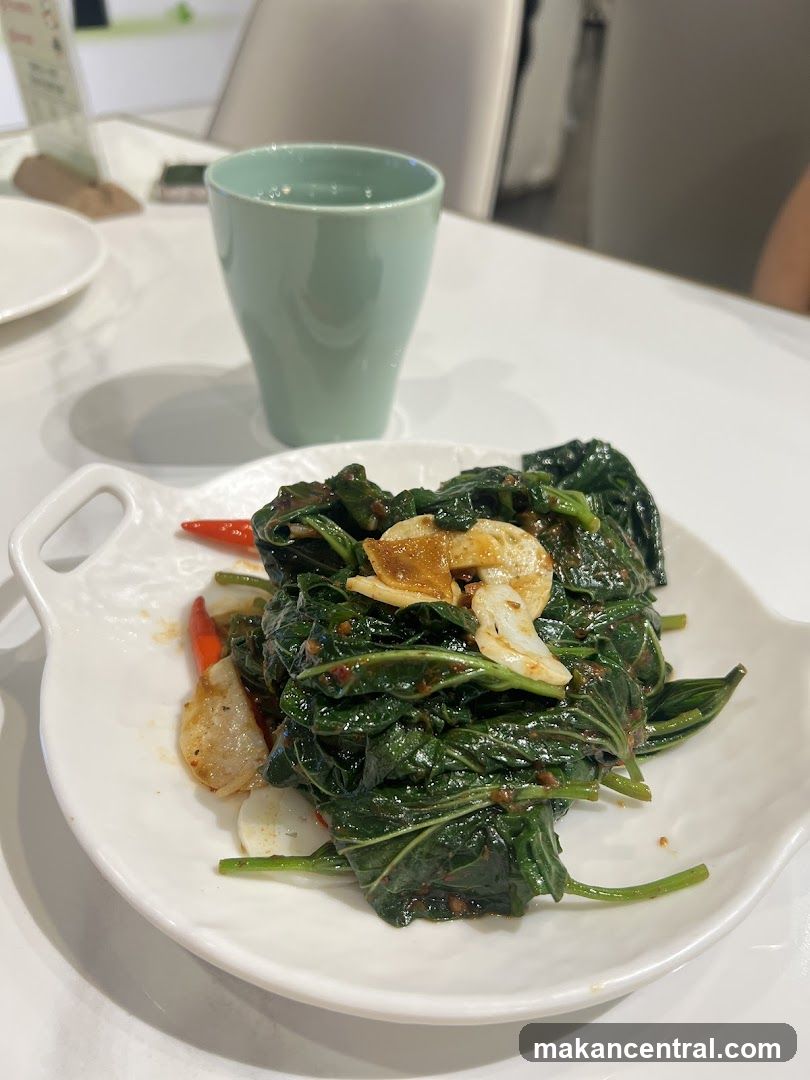 Dining Table with Stir-Fried Greens and Cup