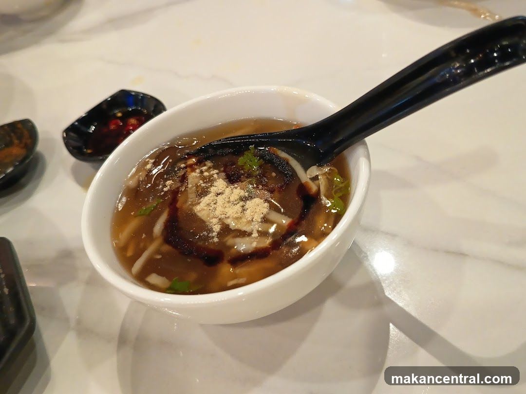 Bowl of soup with spoon on marble table