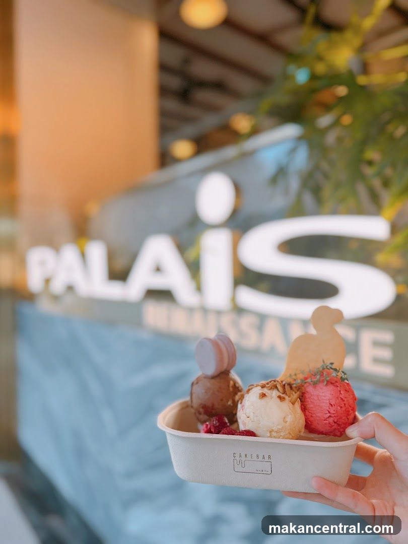 Hand holding dessert in front of shop signage