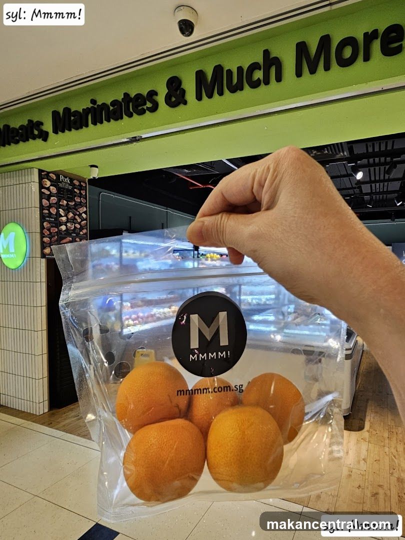Hand holding oranges in a bag at a supermarket