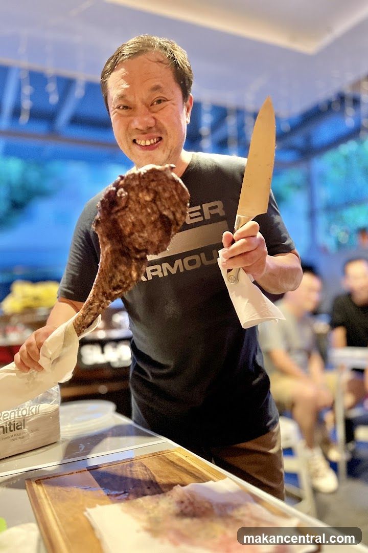 Man holding meat and knife