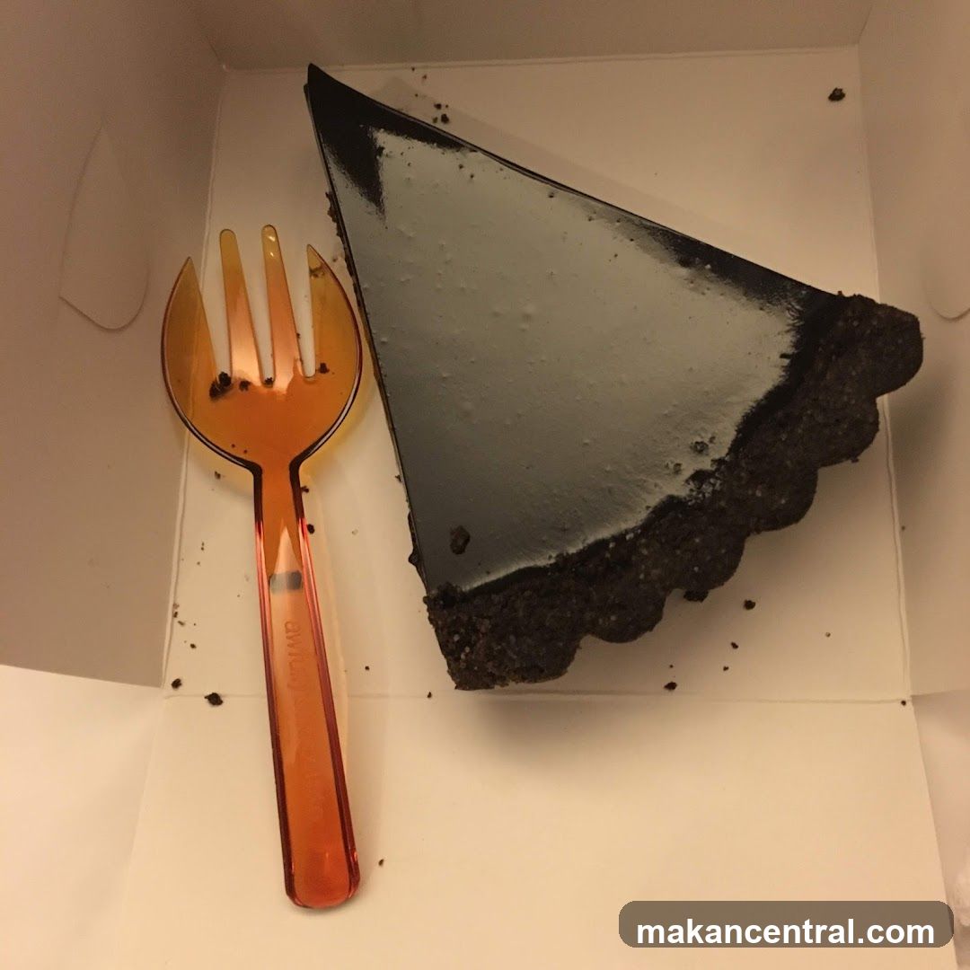 Slice of dessert in box with fork