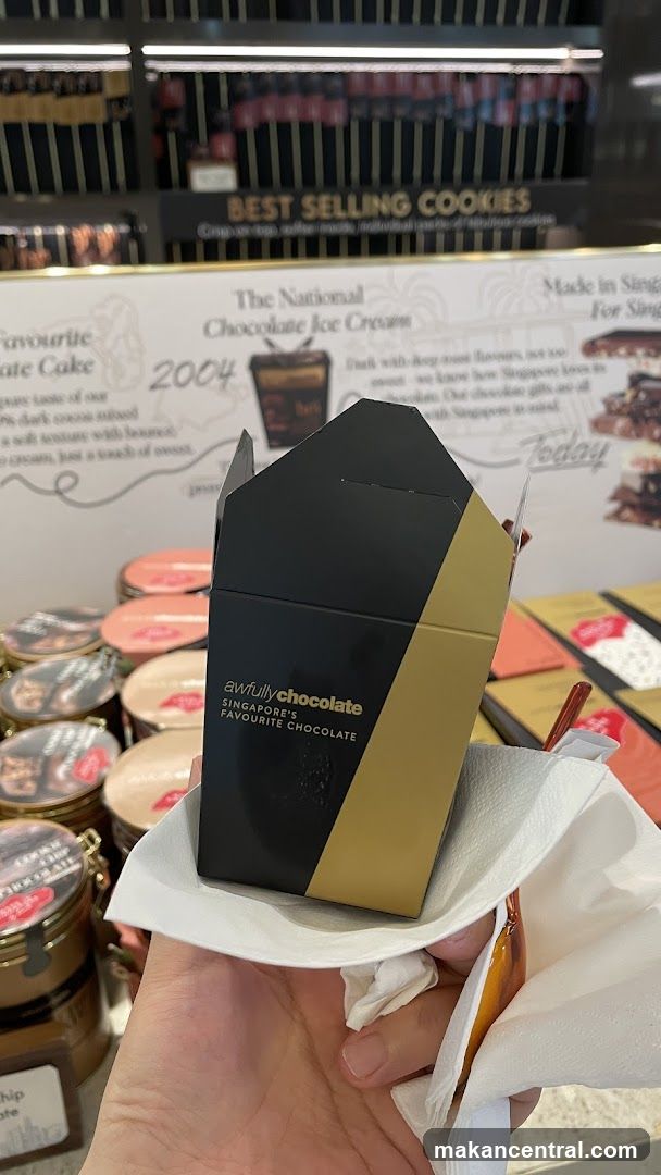 Hand holding chocolate box in store