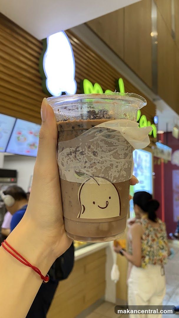 Hand holding beverage in store interior
