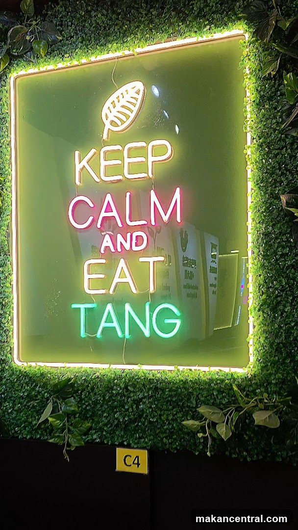 Neon Sign with Greenery Background