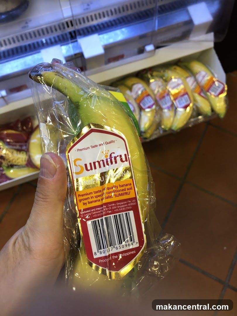 Hand holding packaged banana