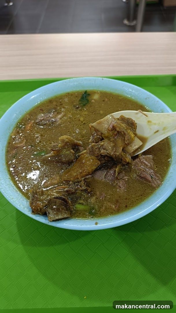 Bowl of stew on green tray