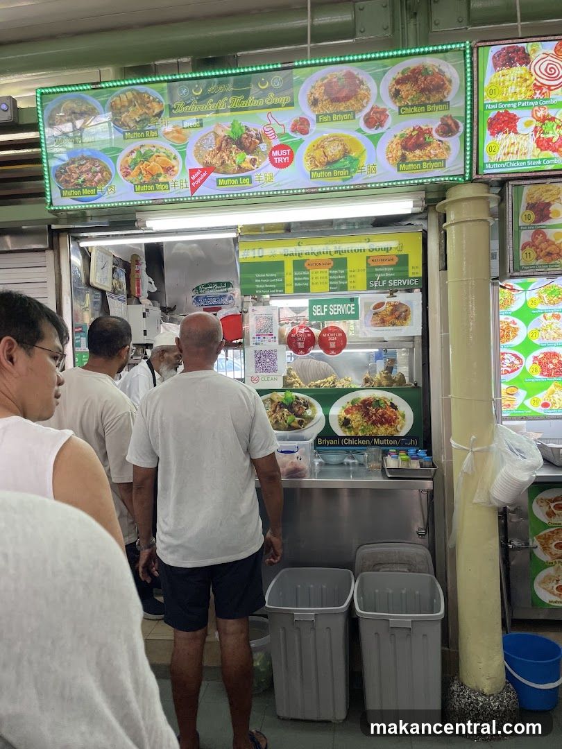 Food stall interior with customers and staff