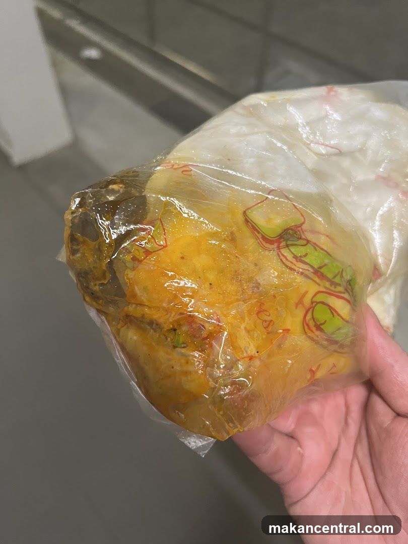 Hand holding wrapped food item