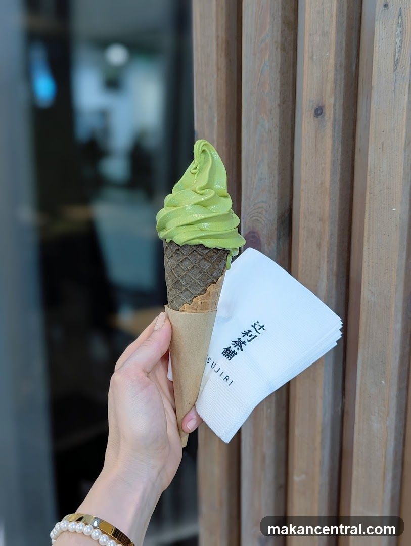Hand holding matcha ice cream with branded napkin