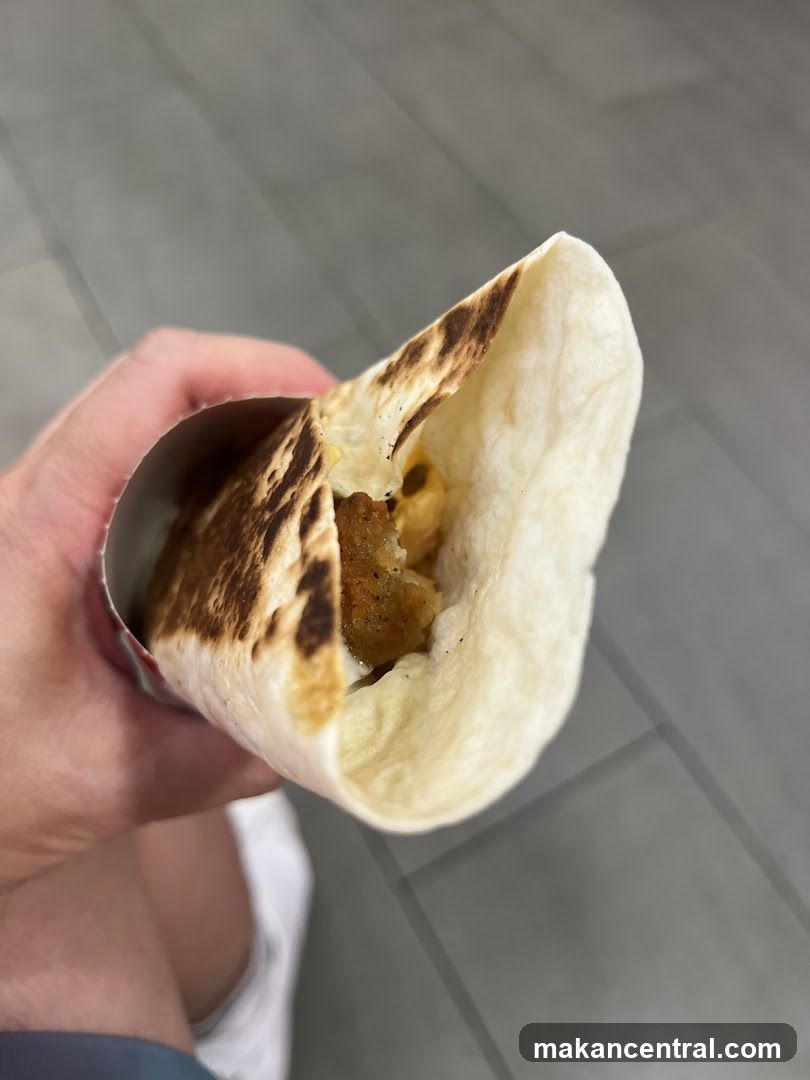 Hand holding a wrapped food item