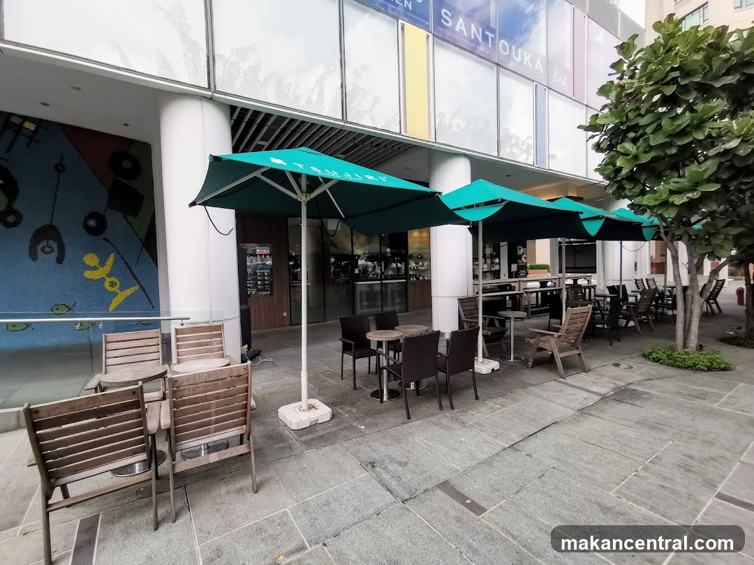 Outdoor seating area of a commercial building with storefront signage