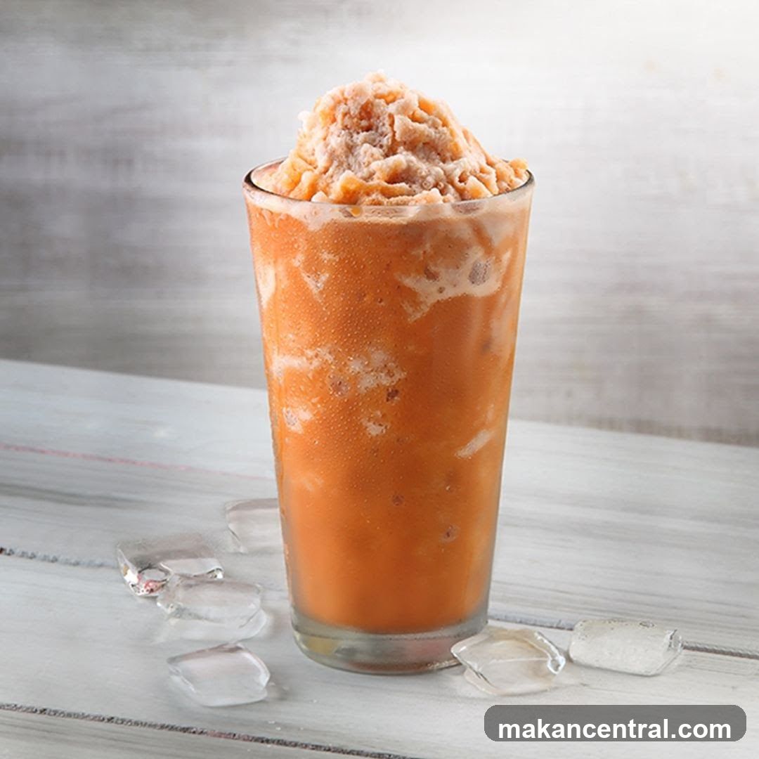 Orange-colored iced beverage with ice cream topping