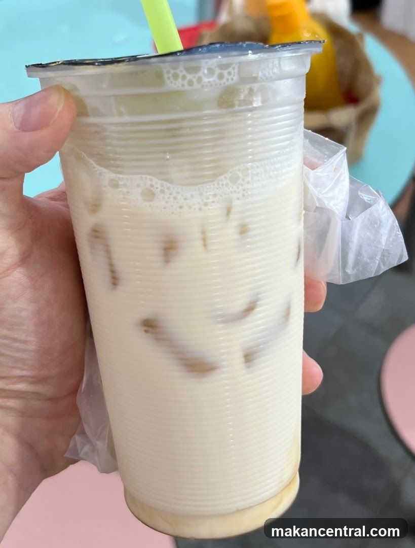 Hand holding iced beverage