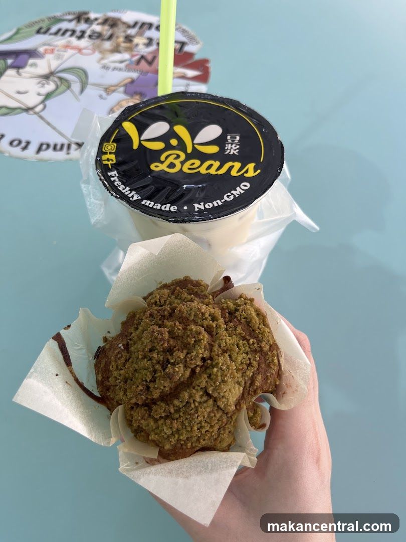 Hand holding food item and drink cup