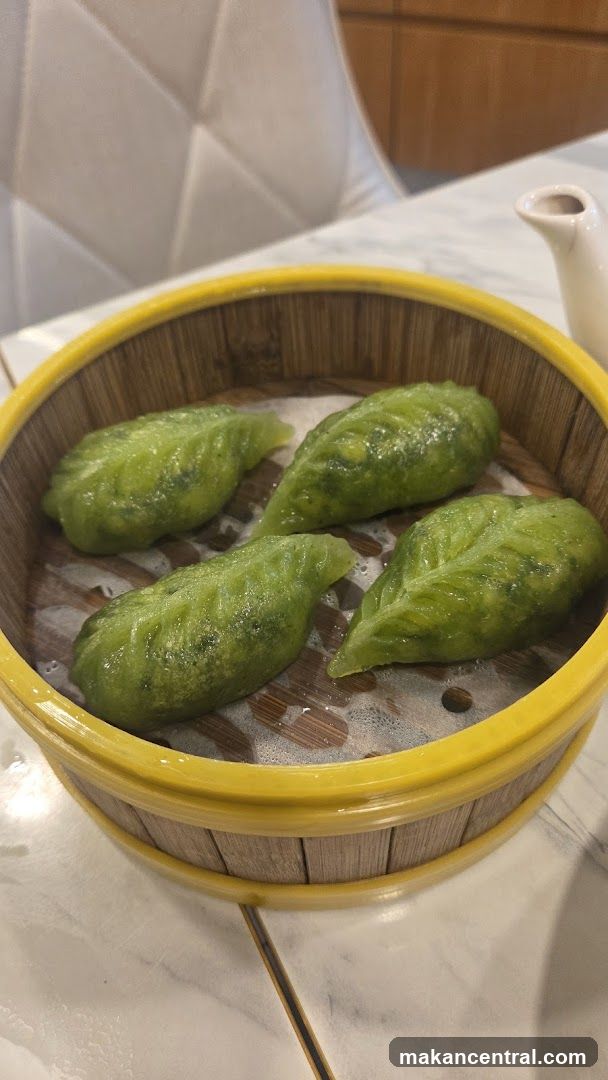 Green dumplings in steamer basket