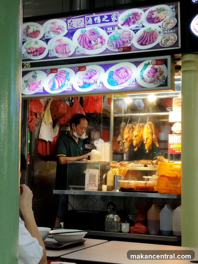 Food stall interior with roasted ducks and staff