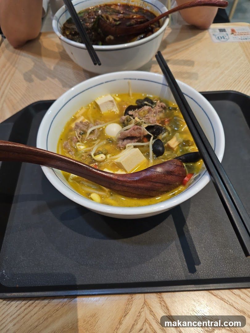 Bowl of soup with chopsticks and spoon