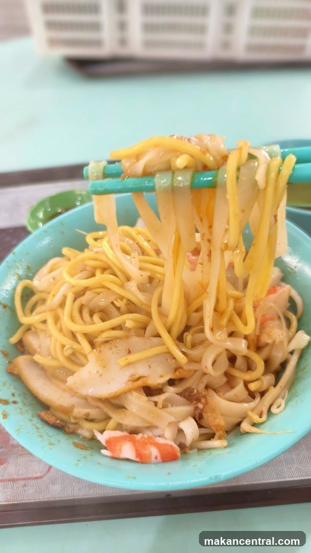 Noodles being lifted with chopsticks