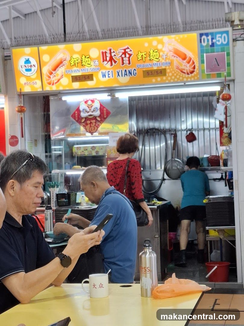 Food stall interior with customers and staff