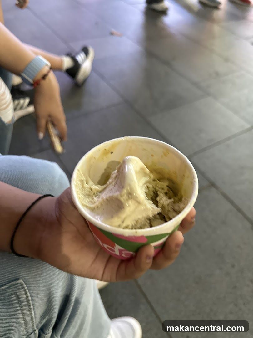 Hand holding ice cream cup