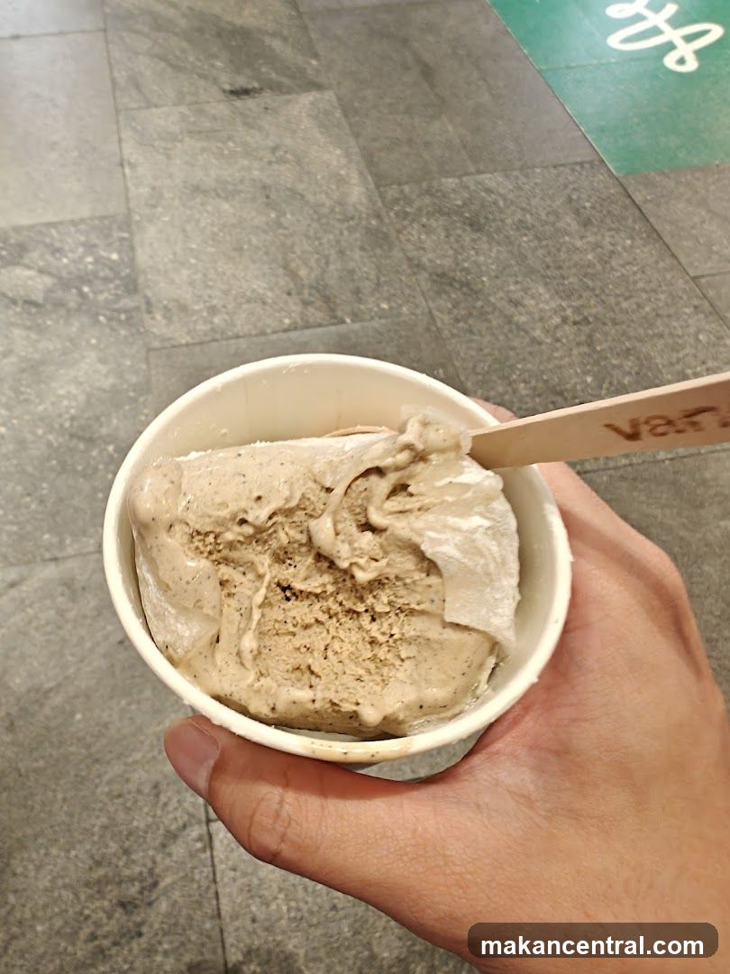 Hand holding ice cream cup