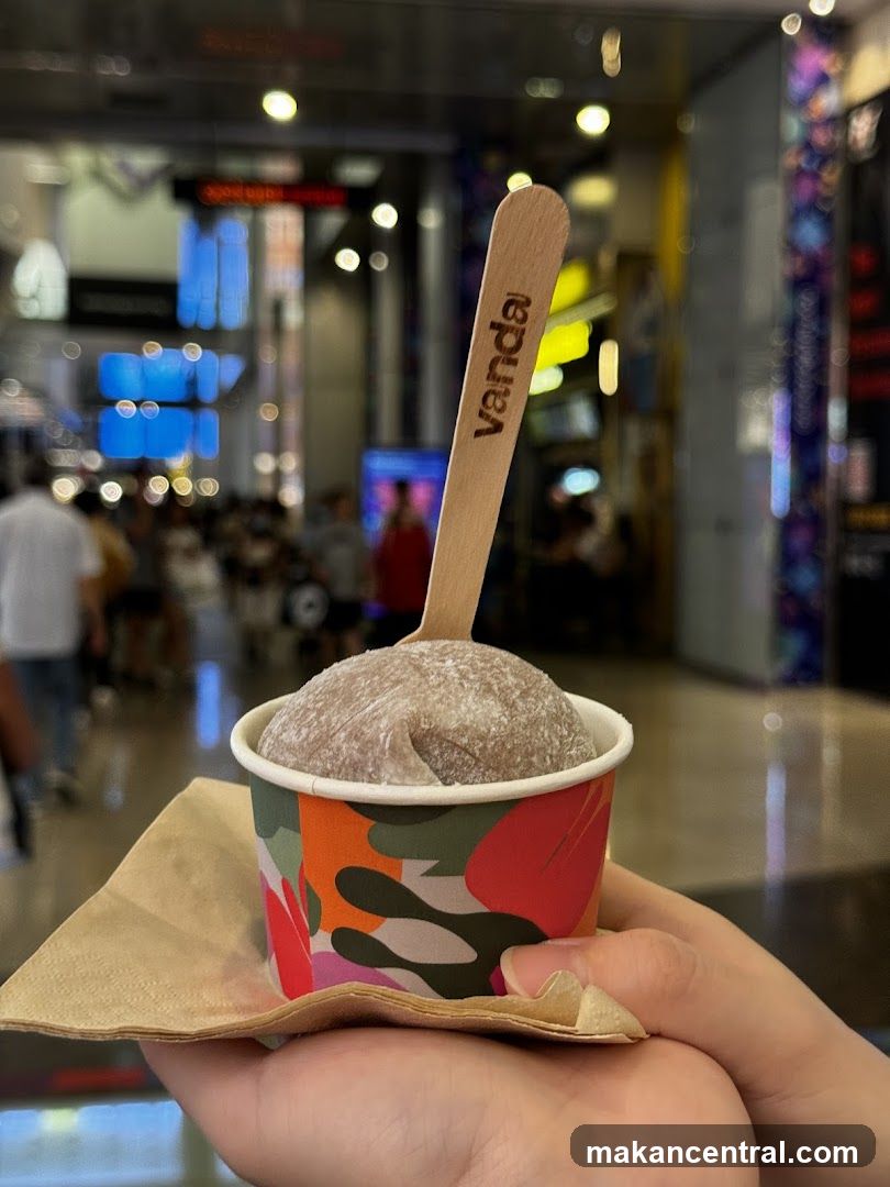 Hand holding ice cream cup